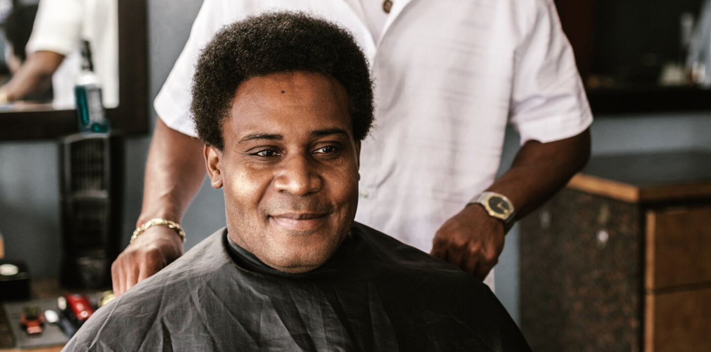 A happy Booksy user at a barbershop.