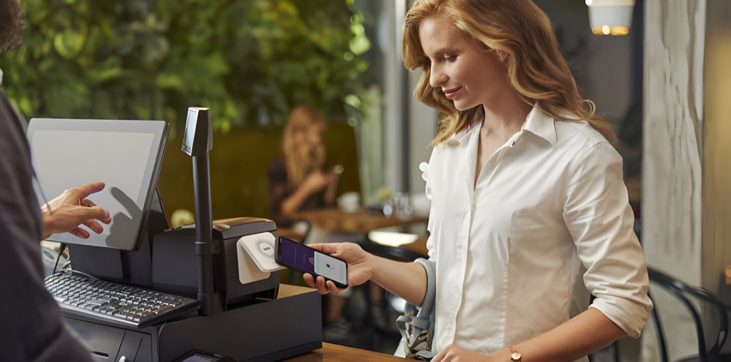 A woman paying with her phone.