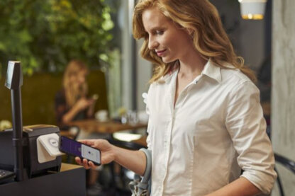 A woman paying with her phone.