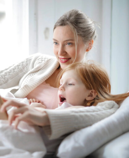 Mother reading to her daughter.