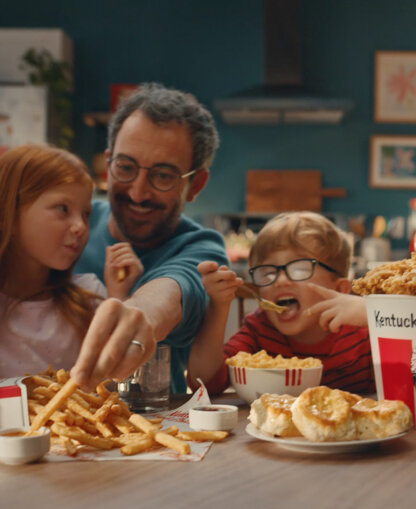 Family of four eat KFC together. Family of four eat KFC together.