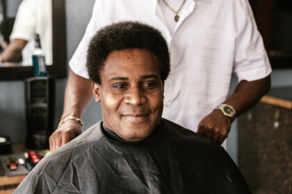 A happy Booksy user at a barbershop. A happy Booksy user at a barbershop.