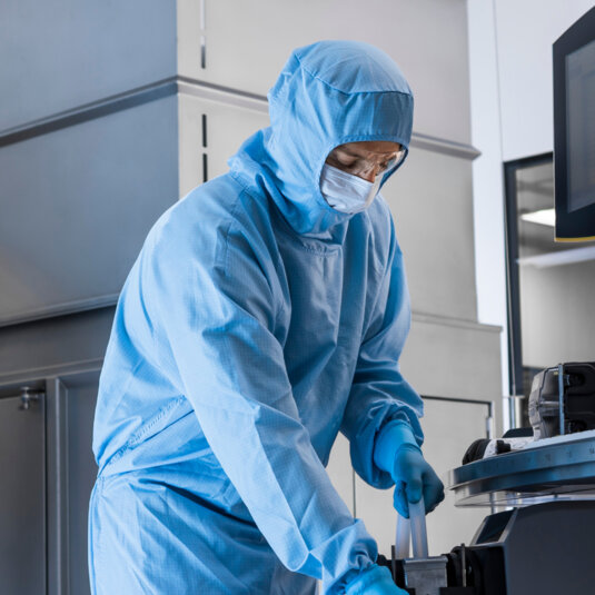 Lab staff preparing a drug. Lab staff preparing a drug.