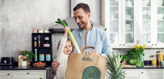 Father and daughter unpacking groceries from delio together. Father and daughter unpacking groceries from delio together.