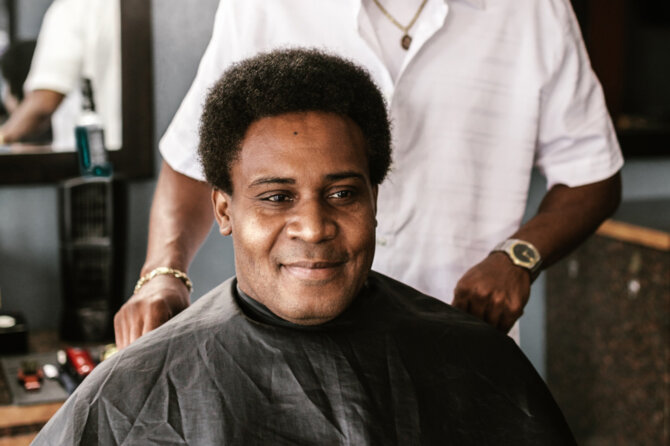 A happy Booksy user at a barbershop.