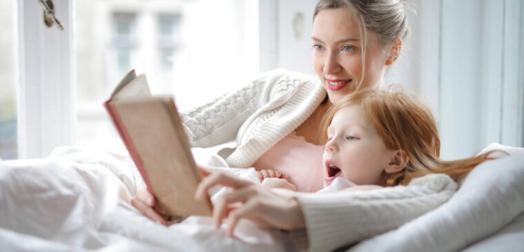 Mother reading to her daughter.